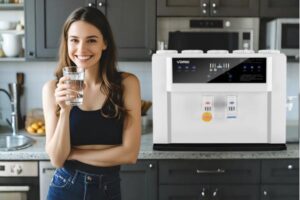 A modern, compact water purifier on a stylish apartment kitchen counter