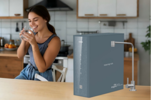 A modern, compact water purifier on a stylish apartment kitchen counter